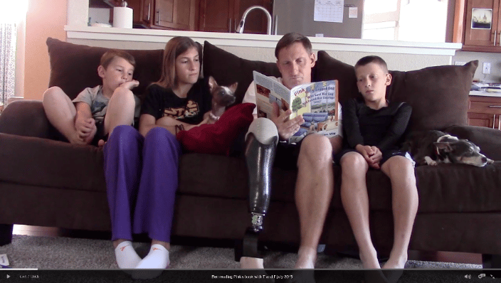 Wounded Warrior Ben reading Pink's book to his children, Pink and Toaster on couch!