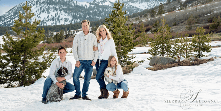 Family in snow with dogs