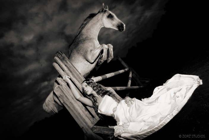 A horse jumping over a bride against a dramatic sky
