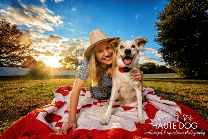 Woman hugging Collie on a blanket