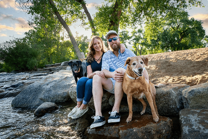 Family with dogs by the creek