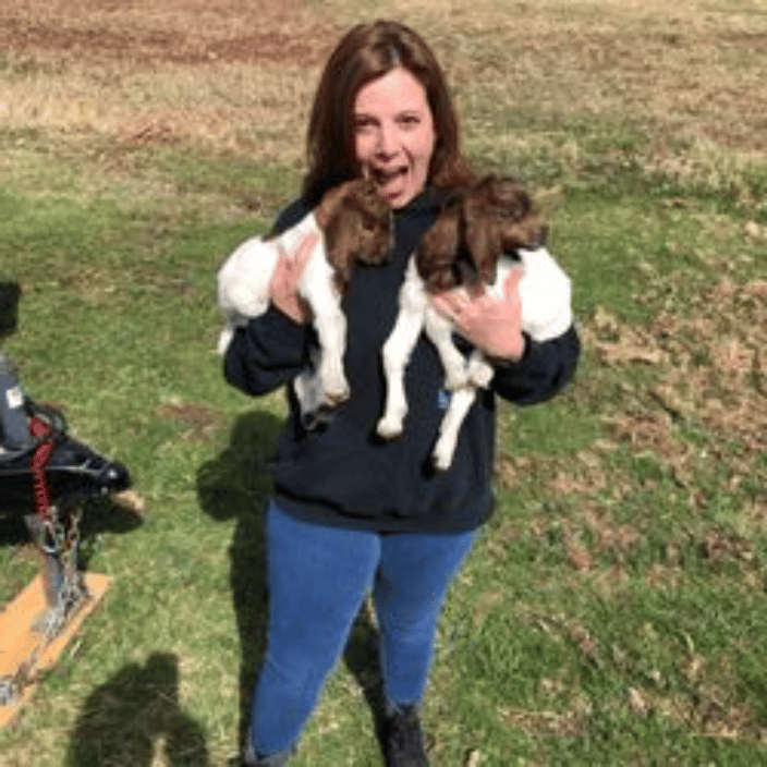 Barbara holding two Boer goat babies