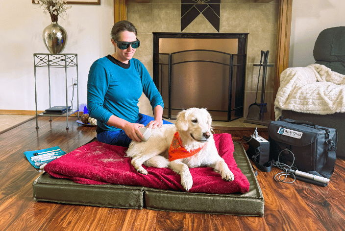 Client Daisy receiving a massage session with cold laser