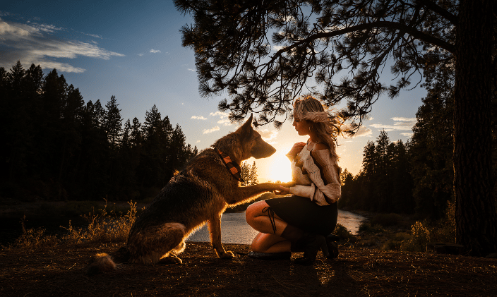 Woman with her German Shepherd at sunset.