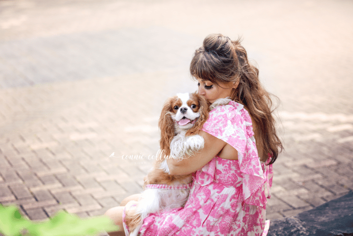 Photo of Woman holding a Cavalier King Charles Spaniel