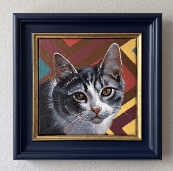 An original acrylic portrait of a domestic short-haired cat against a colorful geometric chevron background